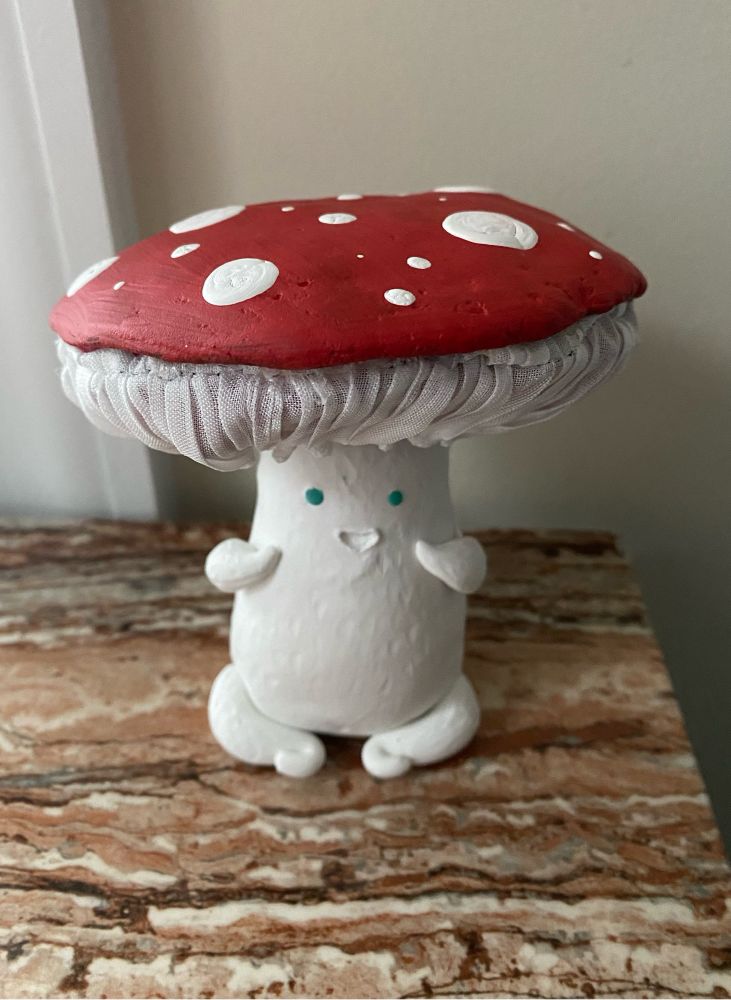 A sculpture of a little mushroom guy