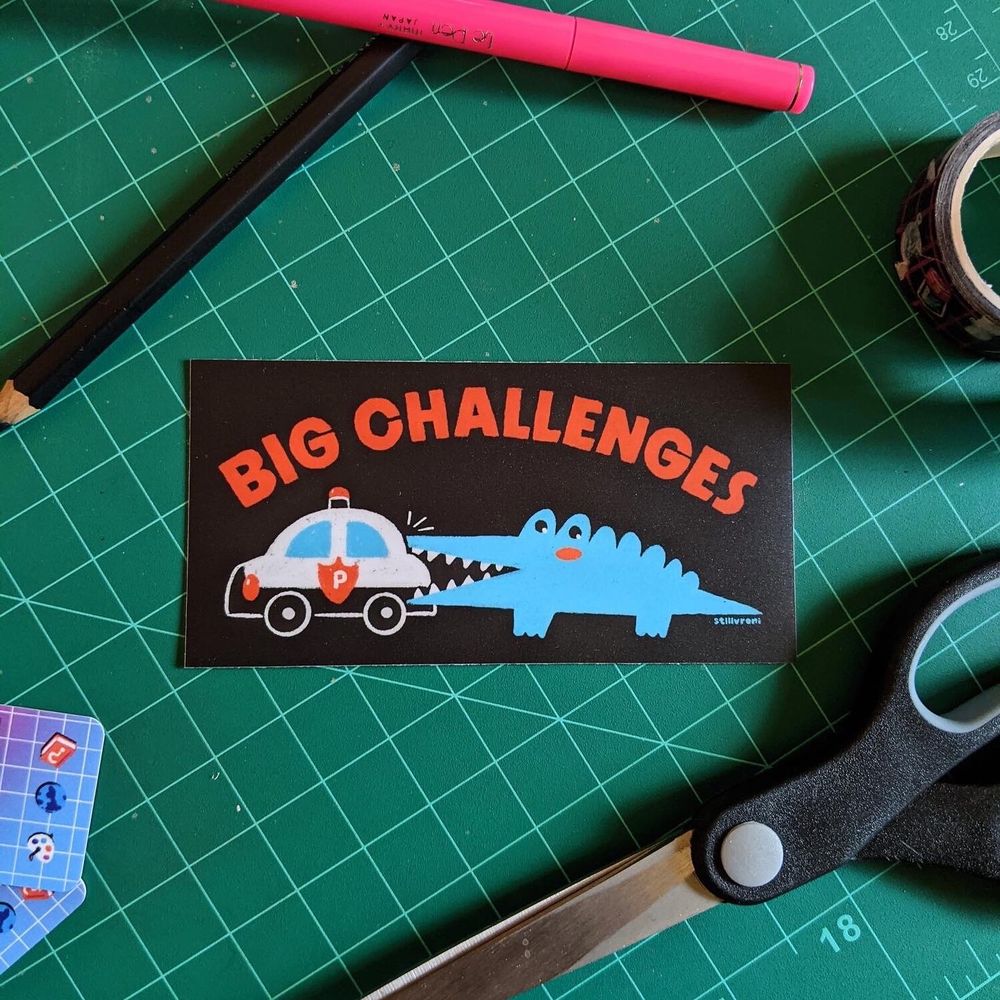 a sticker of the sanrio alligator character big challenges biting a cartoon cop car