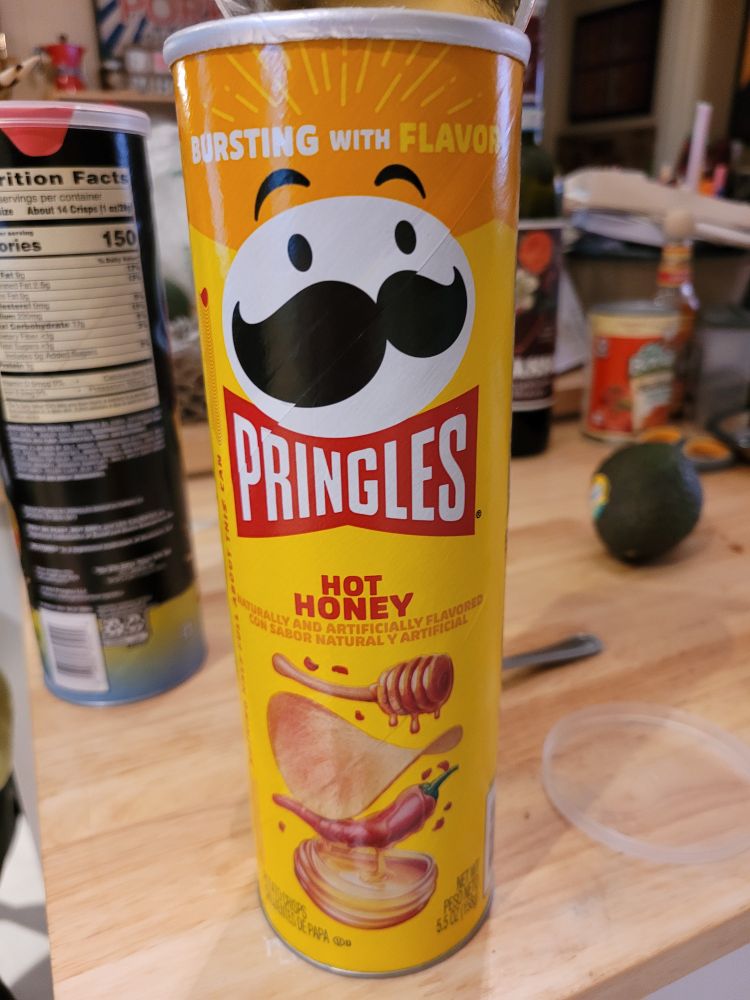 A canister of hot honey flavored pringles