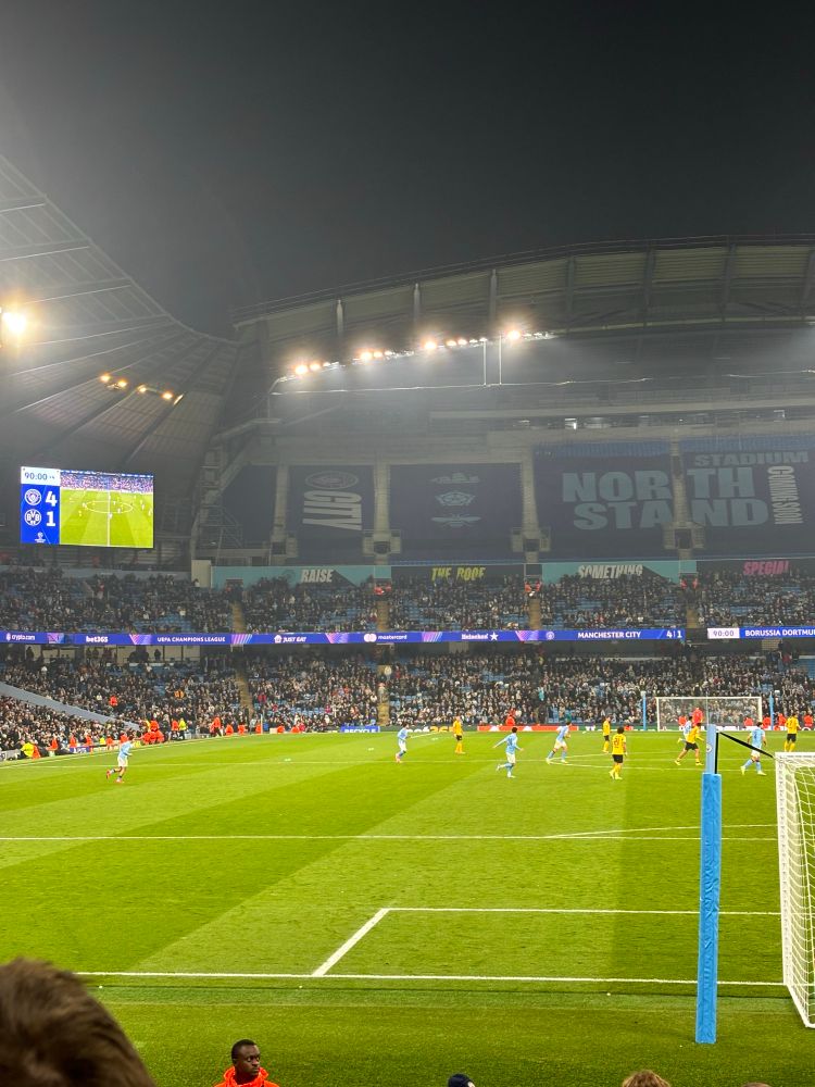 The Etihad pitch near full time of City v Dortmund. The score is 4-1.