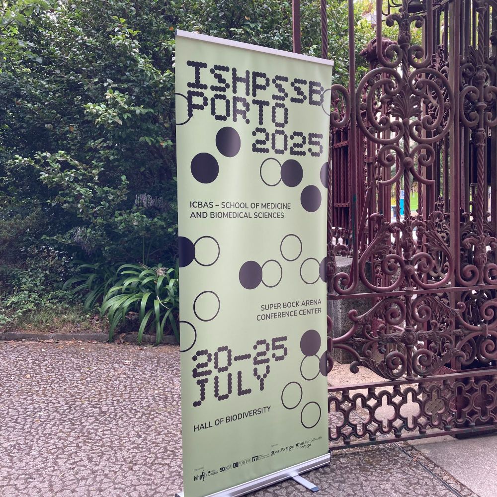 ISHPSSB2025 roll-up (green) in front of the red gate of Hall of Biodiversity and Botanical garden.