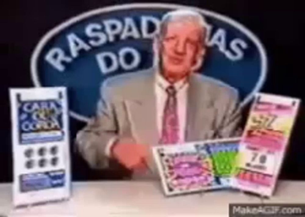 a man in a suit and tie is sitting at a table with a sign that says raspadas do