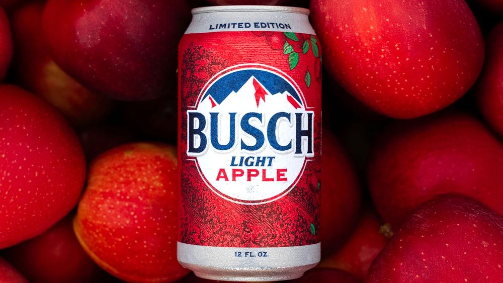 A can of Busch Light Apple in front of red apples
