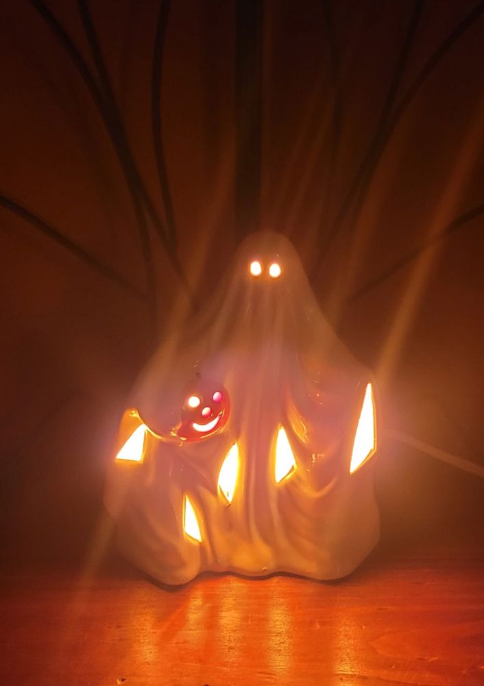 spooky little porcelain ghost lamp who has several glowing rips in his body for some reason. also, black tendrils appear to spring up from behind him like branches