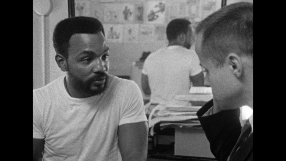 Close-up of two men talking, Ernie Chambers and Bill Youngdahl. A scene from the film A Time for Burning.