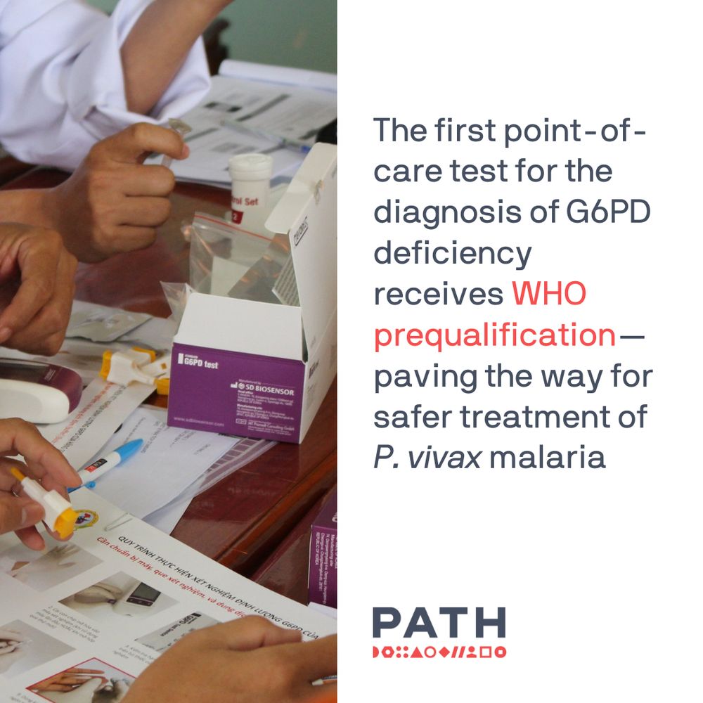 Health workers examining training documents for the STANDARD G6PD test, an accessible point-of-care diagnostic that enables safe and effective malaria treatment. The test is now prequalified by the World Health Organization.