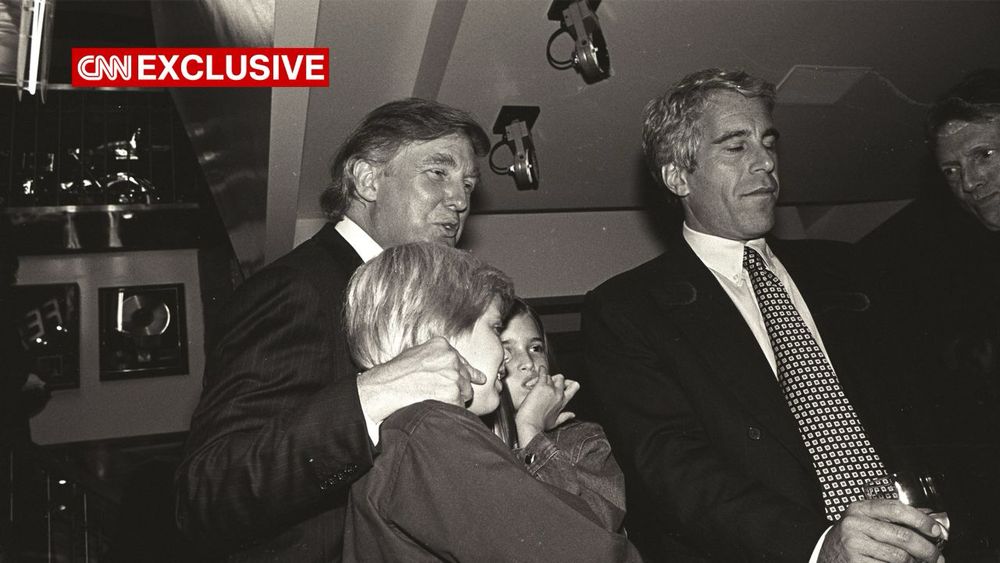Donald Trump, noted pedophile and rapist, holding two children in his lap while sitting next to child sex trafficker Jeffrey Epstein.