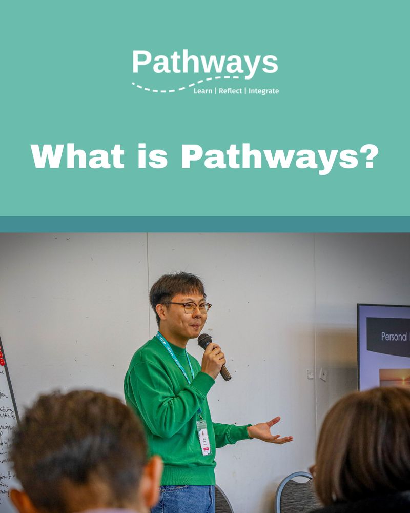 A photo with teal graphic accents of a Pathways facilitator addressing a room with a microphone and a smile. White text reads: What is Pathways? Pathways logo is featured. Photo by Ryan Hunt.