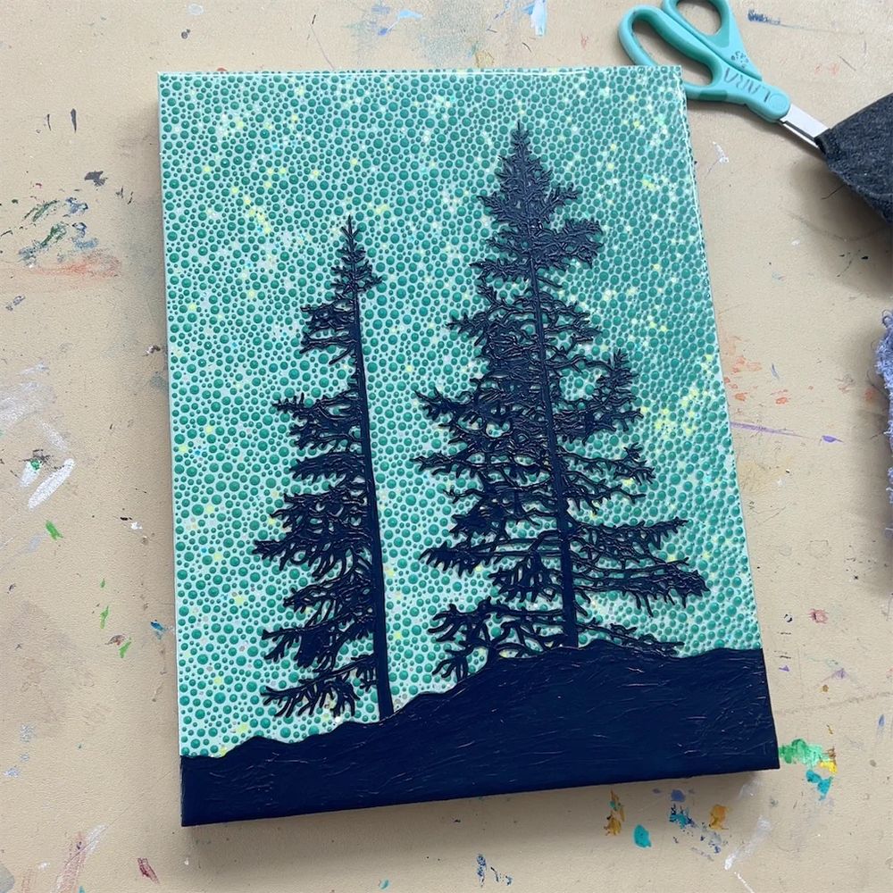 An unfinished painting of two silhouetted trees with a green dot background.