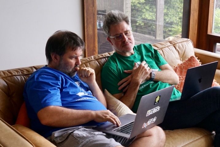 Thing one and thing two sitting on a sofa working on laptops. Classic human pretending to ponder deeply poses (scratching chin / biting nails). Thing two is more puzzled in this photograph.