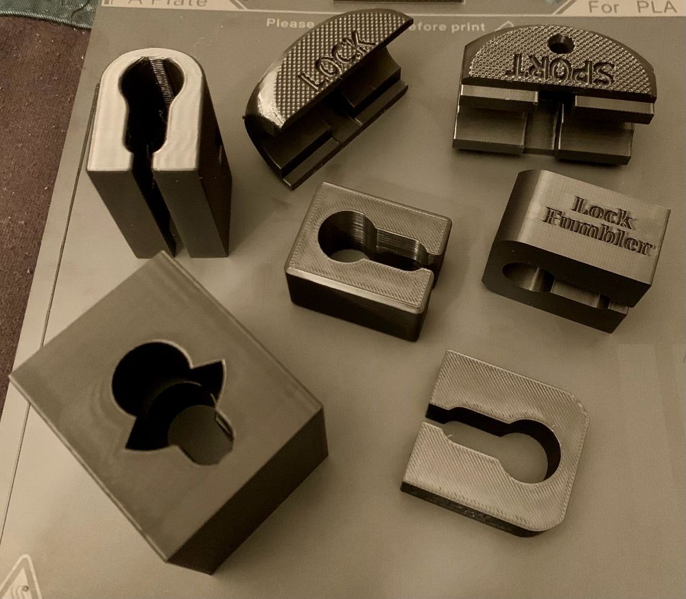 Assorted locksport euro profile cylinder holders off the 3D printer. 
