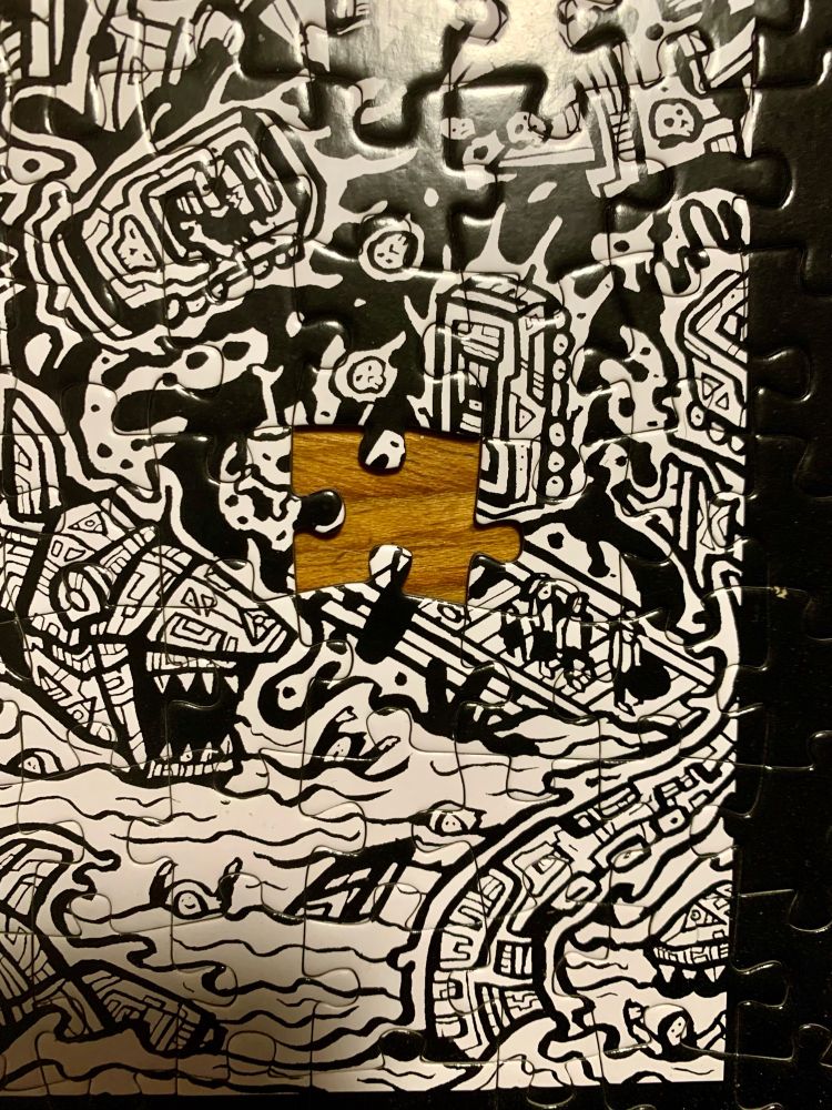 A close up showing the missing piece from an otherwise complete thousand piece dbrand “Robot City” jigsaw puzzle. Current location, unknown… 😭