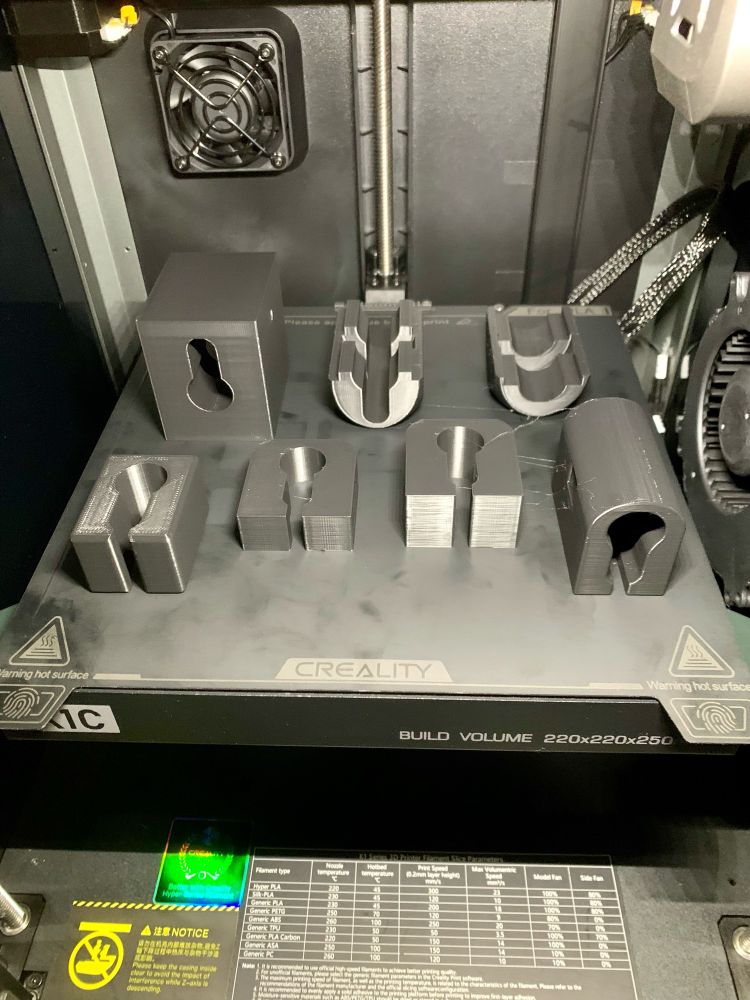 A Creality K1C printer, having finished printing some locksport bits - just waiting for them to be peeled off the print bed. 