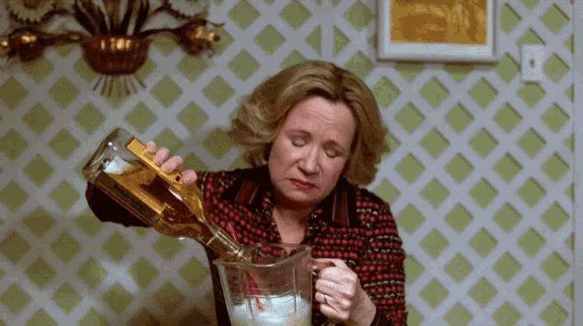 Kitty, from That 70's Show, sadly pours a whole bottle of tequila into a blender which has a straw in it.