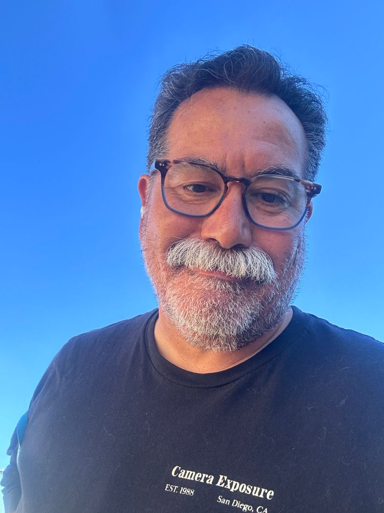 Blue sky selfie with me and a stache, sky background done to not have any identifying info.
