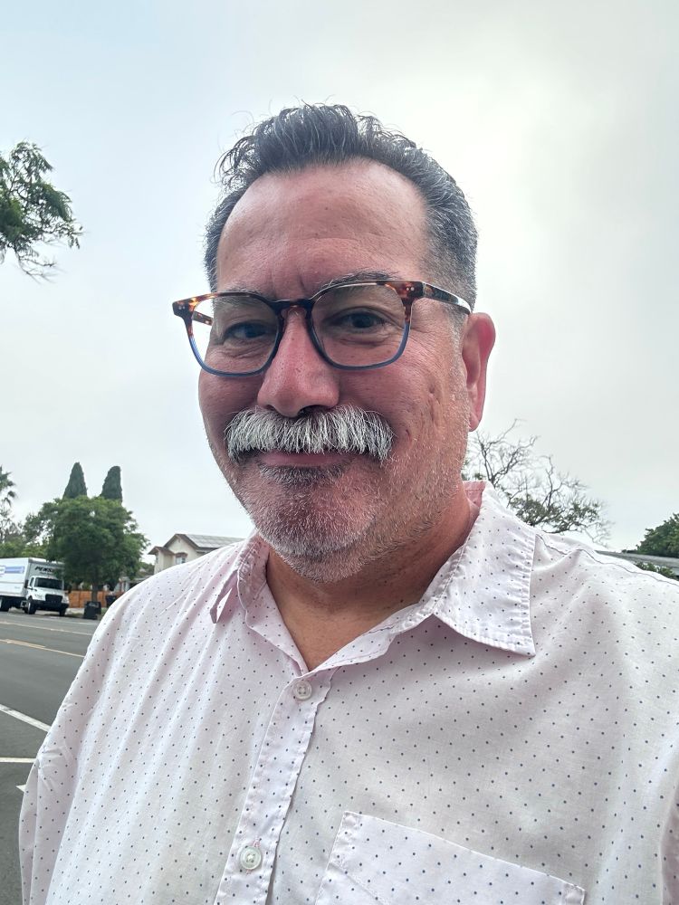 Me with glasses and fresh haircut and stache trim and pink shirt with dots on it.
