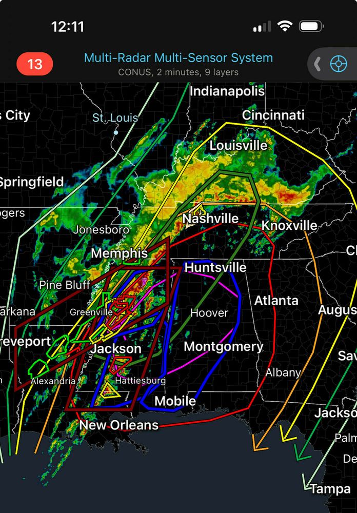 ```Weather radar map showing Multi-Radar Multi-Sensor System with CONUS, 2 minutes, 9 layers. Mobile phone display showing time 12:08 with alert number 13. Map displays severe weather systems across southeastern US with colored precipitation patterns and storm tracking lines connecting cities including St. Louis, Cincinnati, Louisville, Nashville, Knoxville, Memphis, Huntsville, Atlanta, Jackson, Montgomery, Mobile, and New Orleans. Various colored tracking lines (red, yellow, blue, green, purple) indicate storm movement paths.```