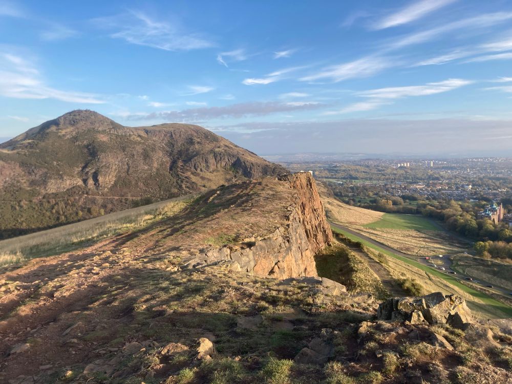 Rocky outcrop and hill (Salisbury Crags & Arthur’s Seat) in Edinburgh, late afternoon. Showing a badly eroded path 