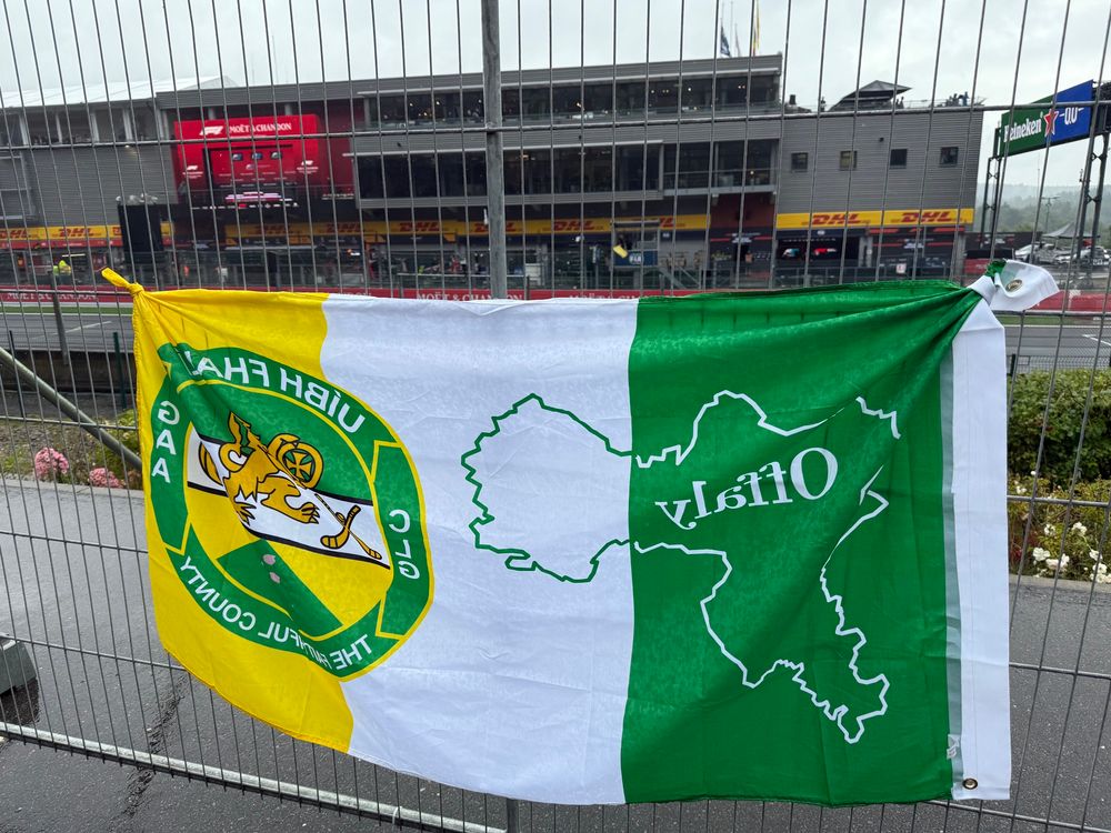 An Offaly flag attached to a fence in front of the podium at Spa Francorchamps.