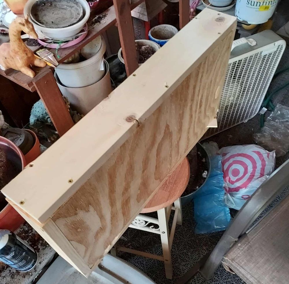 A box assembled and sitting on top of a stool.