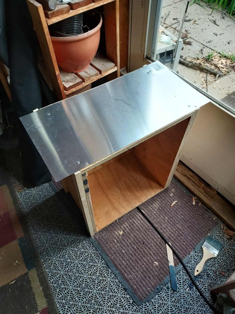 My Little Free Library early on, the box with some wood tacked on the side to dress it up. It has a sheet of aluminum across the top to shield it from rain.