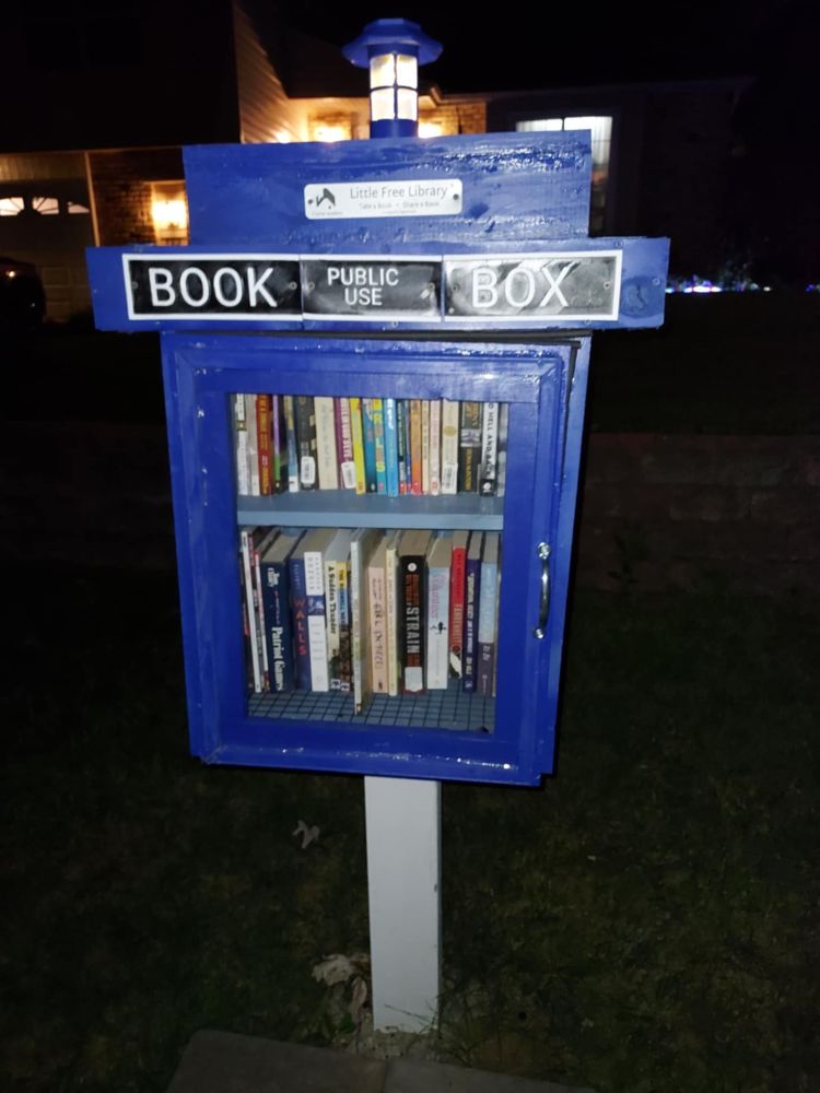 My Little Free Library, restocked, door installed. It has two latches inside to help support its new heavy door.