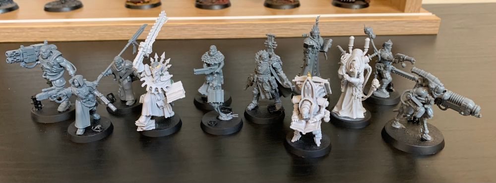 A group of unpainted miniatures, forming a Warhammer 40K Kill Team.