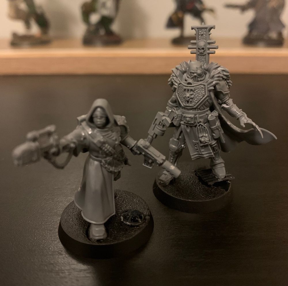 Unpainted Kill Team interrogator and pistolier miniatures.