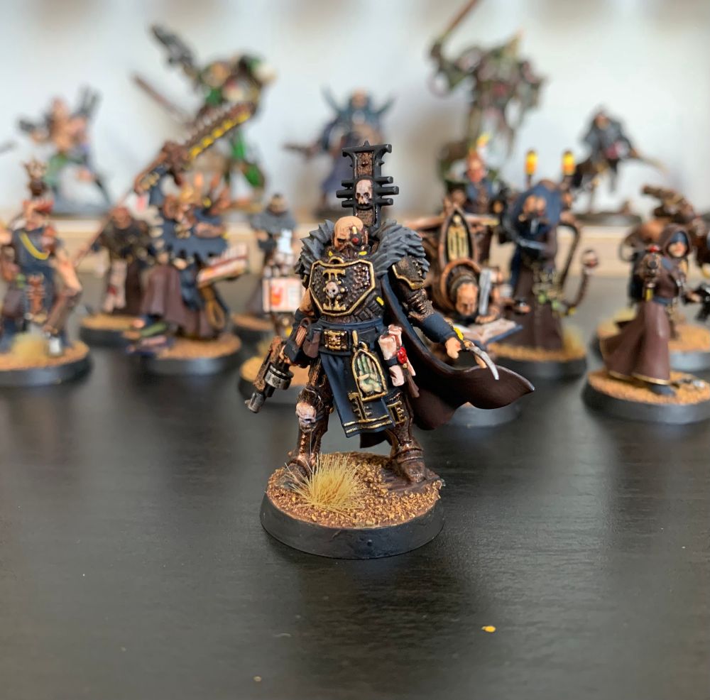 Close up of a painted Interrogator miniature for Warhammer 40k Kill Team, based on the Warhammer+ Inquisitor.