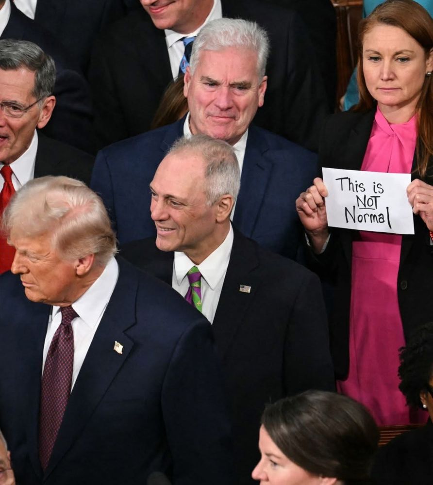 PHOTO: Rep. Melanie Stansbury holds a sign that reads “This is NOT normal” as President Trump entered the House chamber for his joint address to Congress.
