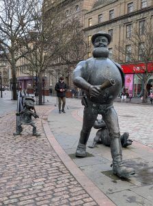 Statues of Desperate Dan, Dawg and Minnie the Minx walking along the streets of Dundee.