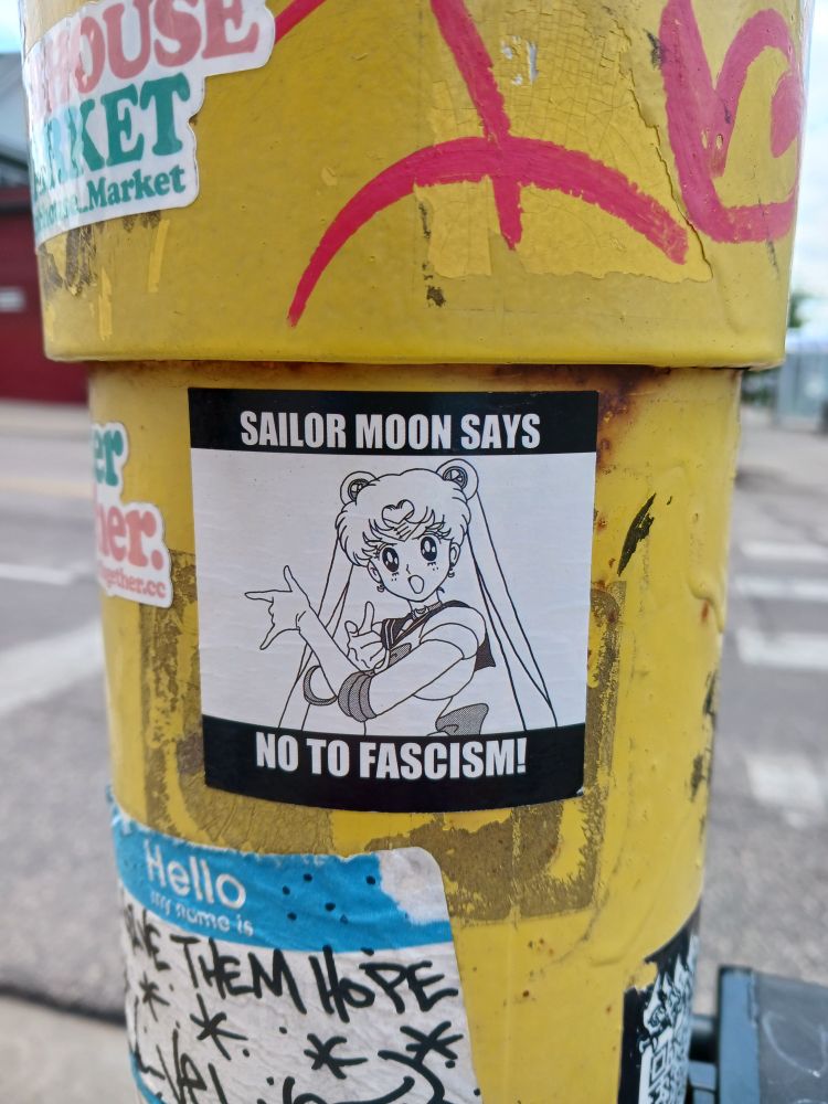 A sticker with a picture of Sailor Moon captioned "Sailor Moon says no to fascism!"