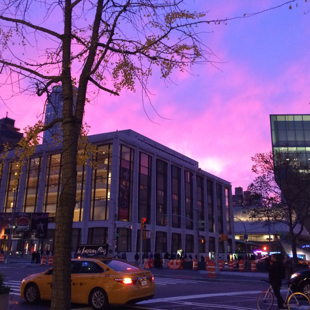 Sunset over Lincoln Center, pink-to-mauve sky.