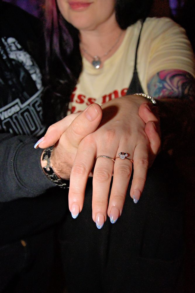 Minnie Mouse ring and really cute nails.