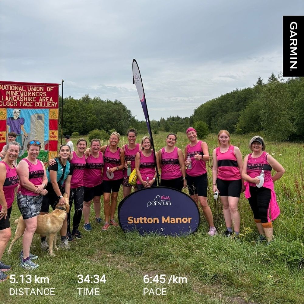 A sea of pink running vests, parkrun banner and miners banner