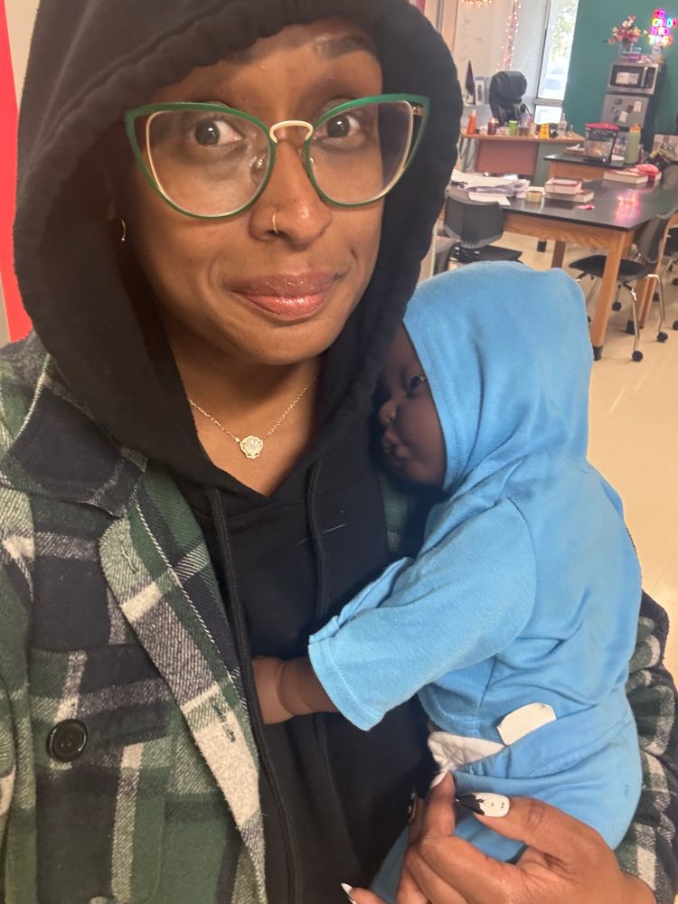 Chanea holding a machine baby