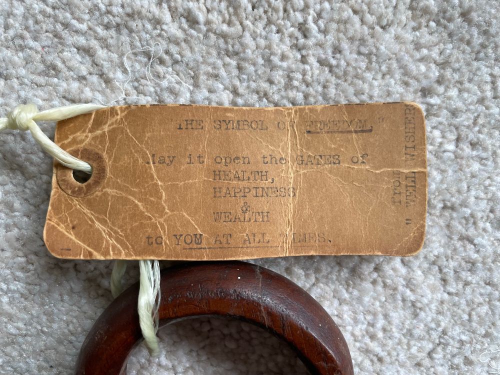 The key’s tag reads: The Symbol of Freedom: May it open the GATES of HEALTH, HAPPINESS, and WEALTH to YOU AT ALL TIMES. From WELL WISHERS