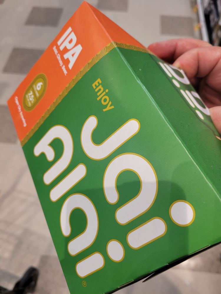 Photo of a six pack of Cigar City Brewing's "Jai Alai" IPA, the packaging is green and orange with white lettering trimmed with a gold outline