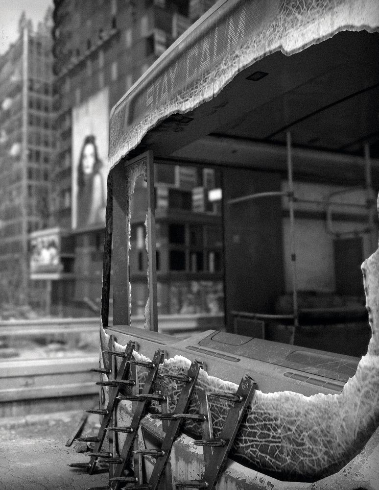 Dying Light 2: scenery shot in b&w; close up of a bus with shattered windows and the text "Stay Calm" at the top and bloody spikes attached to its front. The city can be seen behind it; two tall buildings with billboards (blurred) of which one appears to show a woman.