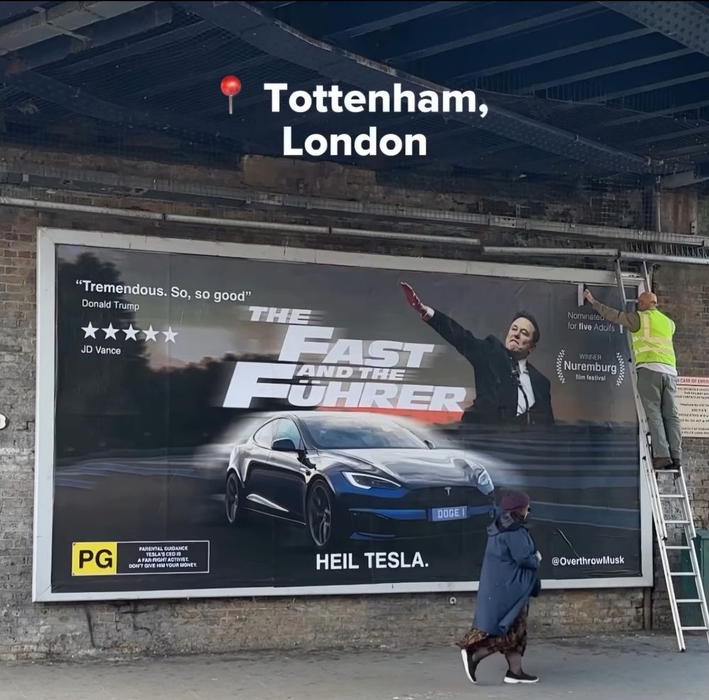 A parody billboard for a movie called The Fast and the Fuhrer, with Elon Musk throwing a sideways Nazi salute, above a Tesla, with a caption Heil, Tesla.