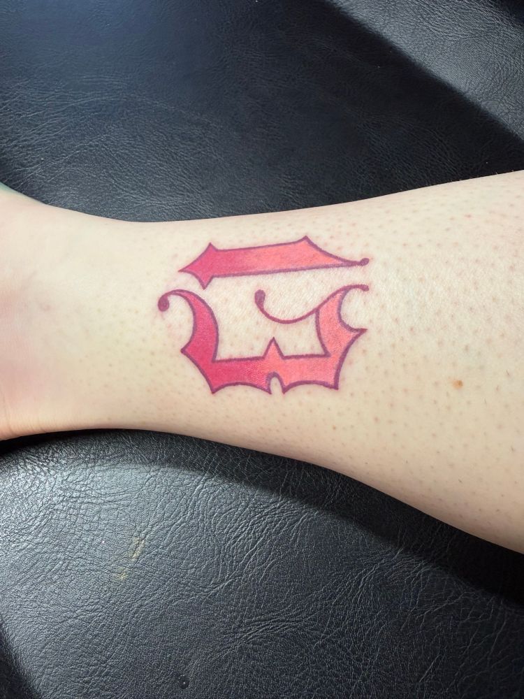 A tattoo on the inner right ankle of an ombré pink 13