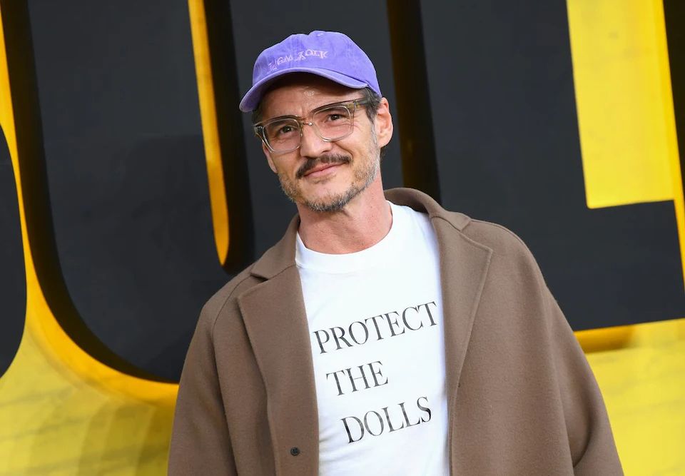 Pedro Pascal wearing a white Protect the Dolls T-shirt 