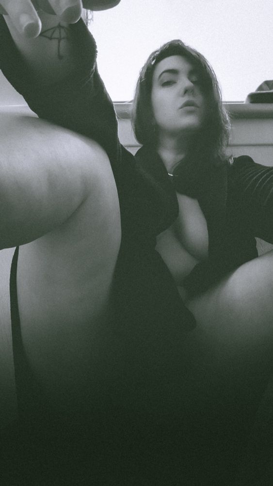 Curvy woman posing for portrait in filmy black and white 