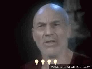 a close up of a bald man 's face with three light bulbs around his neck .