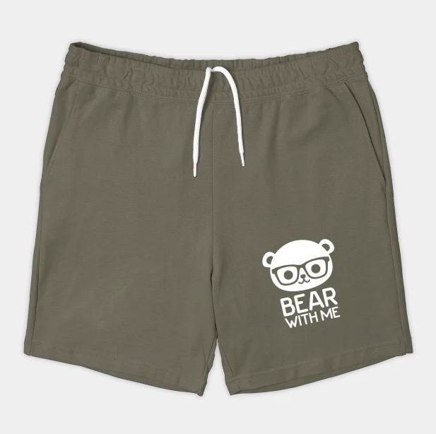 Image of a pair of cotton shorts: Bear with me is written at the bottom of the left leg with an illustration of a cut bear with thick rimmed glasses
