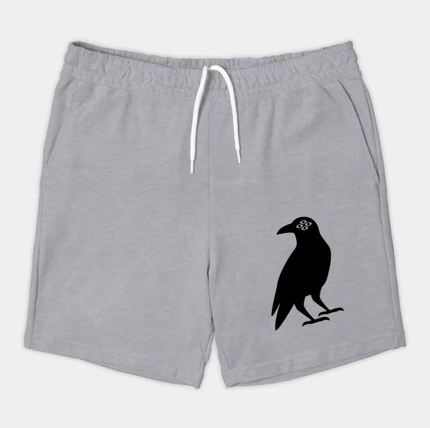 Image of a pair of cotton shorts: an illustration of a black raven with 4 eyes is printed at the bottom of the left leg