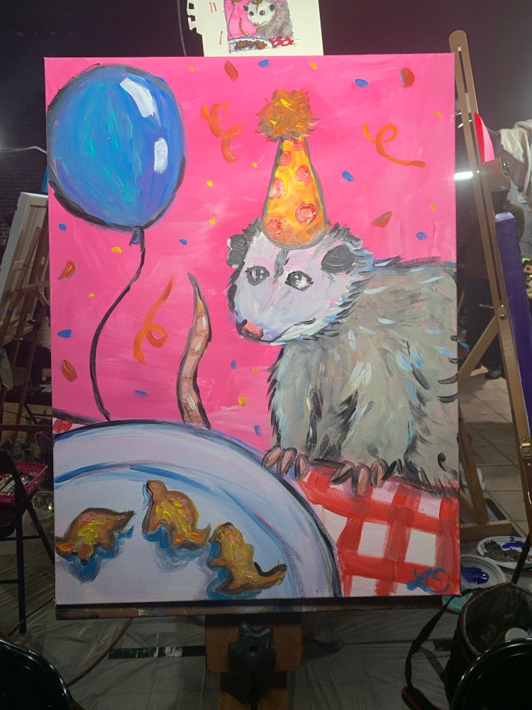 Painting of possum with party hat eating dino nuggets. Bright pink background. 