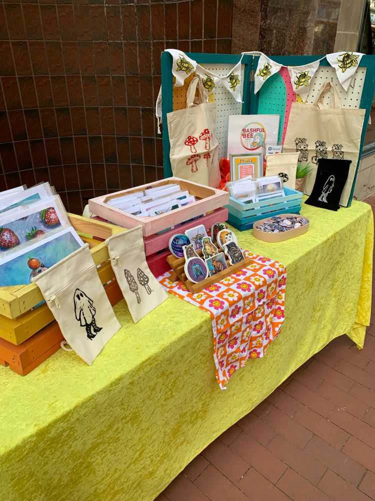 Yellow table cloth and boxes of art prints 