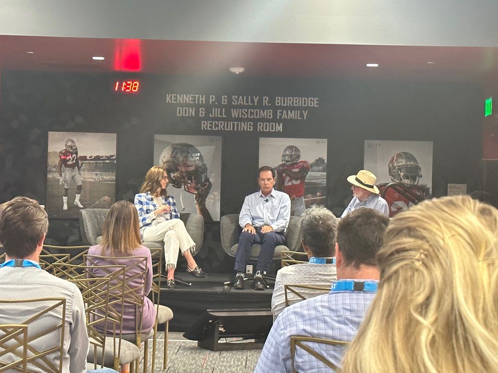 Molly Mazzolini, Fraser Bullock and Tom Kelly speaking on stage at the SEAT conference