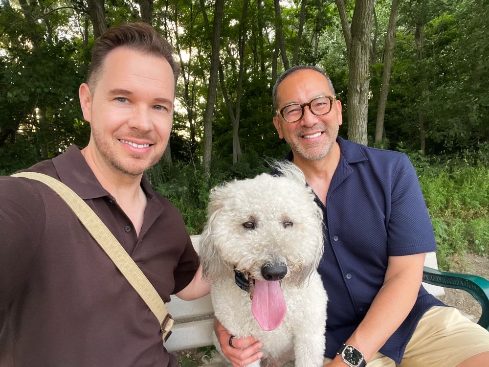 Me, James and our dog sitting in a park bench 